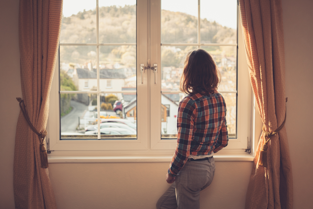 Young woman looking out the window